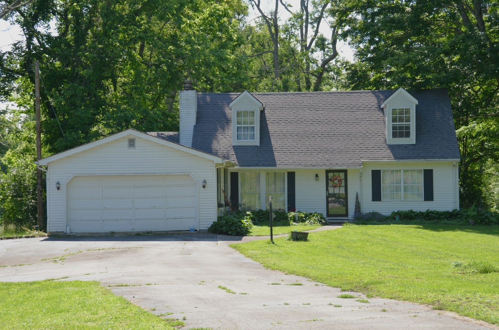 White two-car garage door on a suburban house
