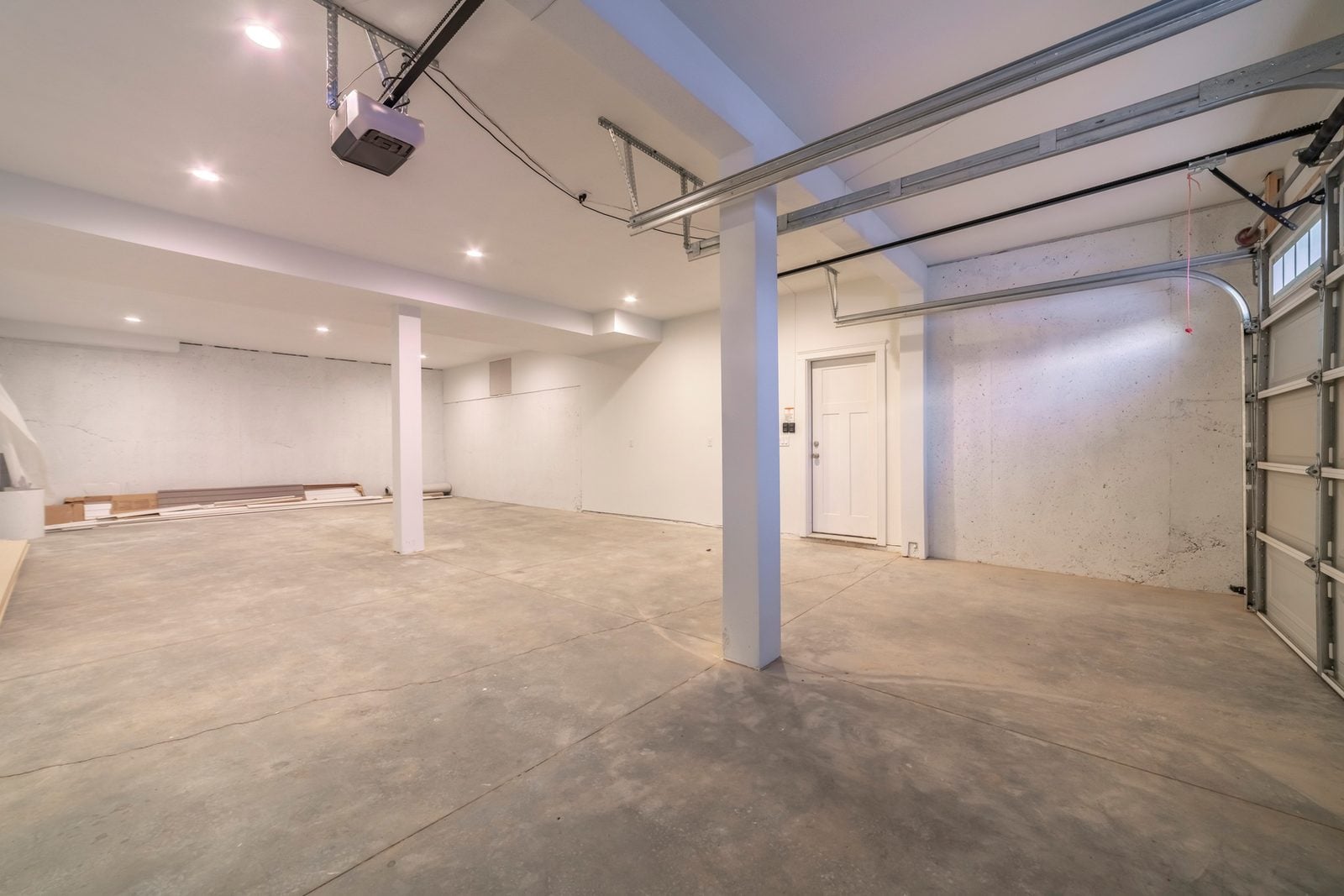Empty garage with a ceiling-mounted automatic door opener motor